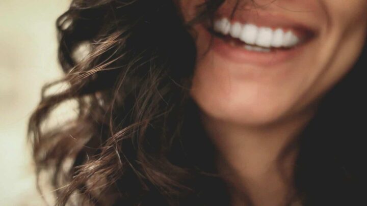 long black haired woman smiling close-up photography
